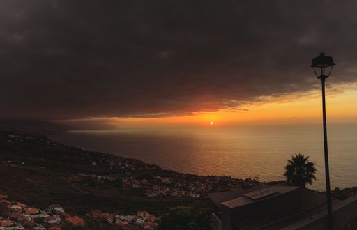 A high angle shot of the breathtaking sunset reflecting in the ocean at the beach town