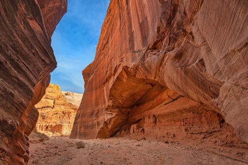 A narrow crevasse filled with bright red-colored rocks, Utah Canyons