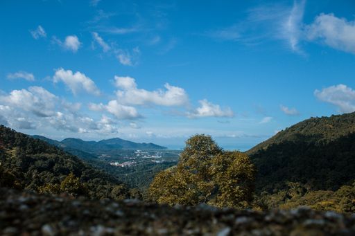 A beautiful scenery of high grassy mountains under the cloudy sky