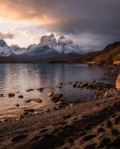 A vertical shot of the Torres del Paine mountains under a cloudy sky in Chile
