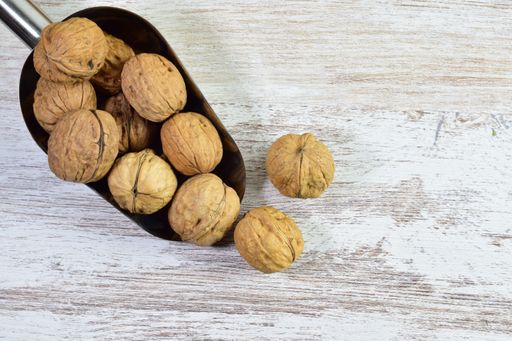 A top shot of walnuts on a wooden table