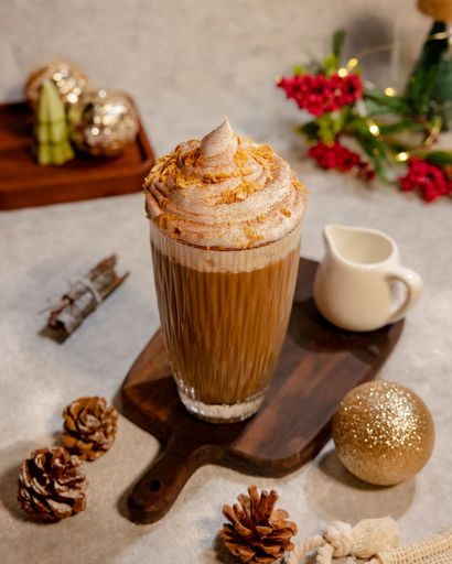 A vertical shot of a Christmas coffee with whipped cream on top