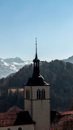 A vertical shot of the Eglise Saint Theodule church dome in Gruyeres, Switzerland