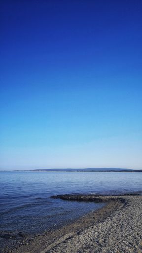 A vertical shot of the marvelous calm ocean during the evening time