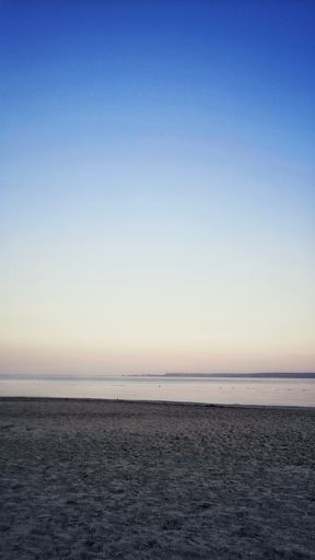 A vertical shot of the marvelous calm ocean during the evening time