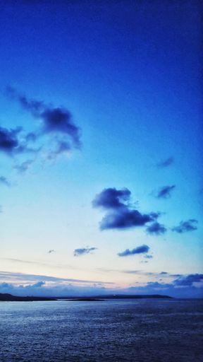 A vertical shot of the marvelous calm ocean during the evening time