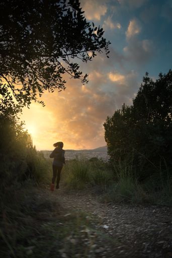 Latin woman runs through the mountains as part of her daily training.
