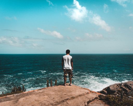 A person standing at the ocean shore in Rio de Janeiro