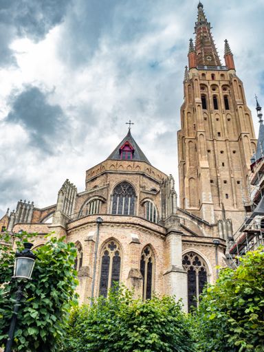 A low angle shot of Church of Our Lady Bruges in Belgium under a cloudy sky