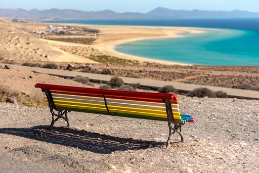 A colorful bench to contemplate view in the shore of Playa de Sotavento in Spain