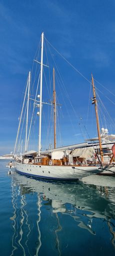 A luxurious private yacht docked near the pier on a bright sunny day in Antibes, France