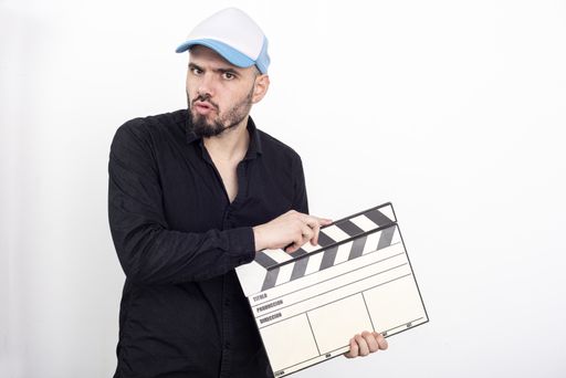 A guy holding a clapperboard isolated on white background