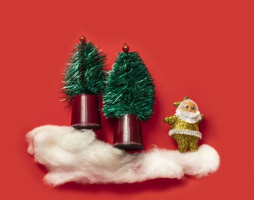 A collage of a golden miniature Santa Claus in the snowy forest with Christmas trees