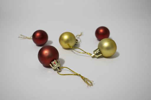 A high angle shot of Christmas ornaments on a white surface