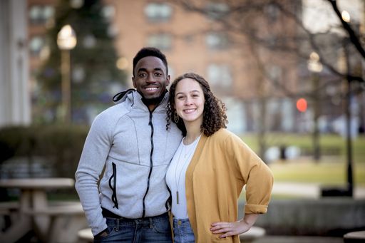 A cute selective focus shot of two friends smiling and posing together