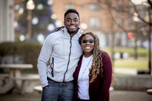 A cute selective focus shot of two friends smiling and posing together
