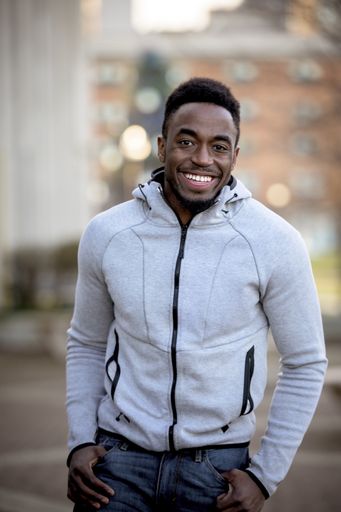 A vertical shot of an attractive African American male smiling at the camera