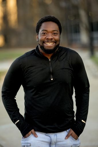 A vertical shot of an attractive African American male smiling at the camera