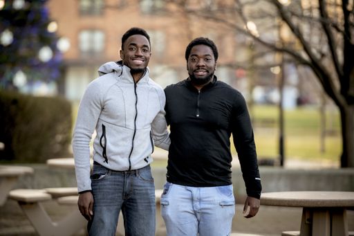 A cute selective focus shot of two friends smiling and posing together