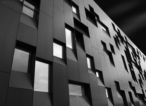 A low angle  shot of a creative modern building with outstanding architectural twists