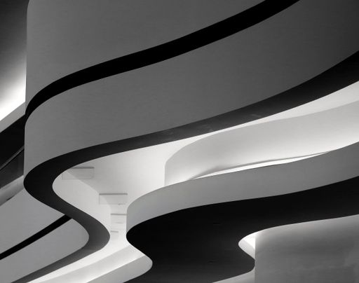 A closeup greyscale shot of a building with curvy twists in Berlin, Germany