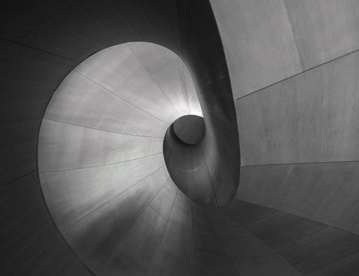 A greyscale shot of a unique piece of architecture perfect for a creative background