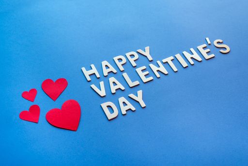 A closeup shot of Happy Valentine's day celebration text over blue background