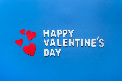 A closeup shot of "Happy Valentine's Day" text on blue background