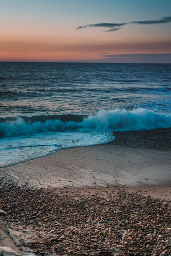 A vertical shot of a beautiful sunset captured at the beach