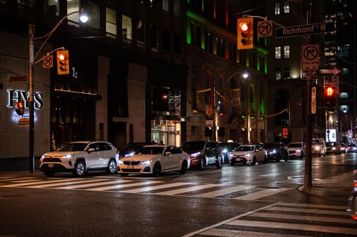 many cars waiting in traffic light for green signal to go.