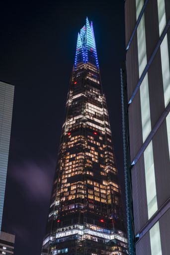 A vertical low angle shot of The Shard captured at night in London, UK