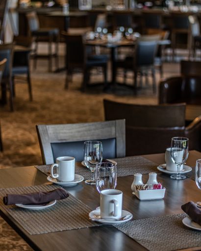 A vertical shot of neat tables in a nice, empty and clean restaurant