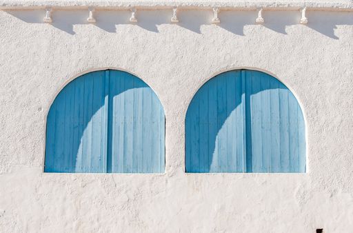 A closeup shot of blue wooden windows f  Mediterranean house