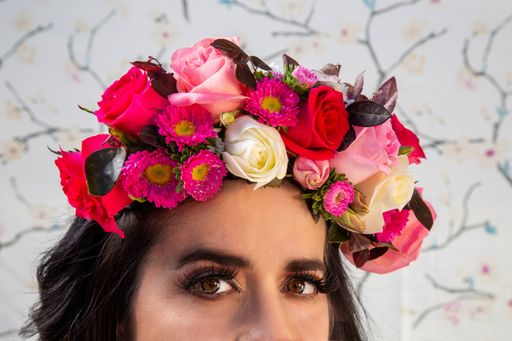 A closeup shot of a young Hispanic female with flowers in her hair