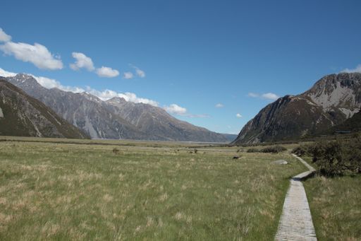 A beautiful view of the mountain chain covered in snow and the field