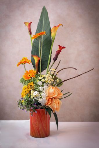 A vertical shot of a beautiful bouquet of flowers on the grey background