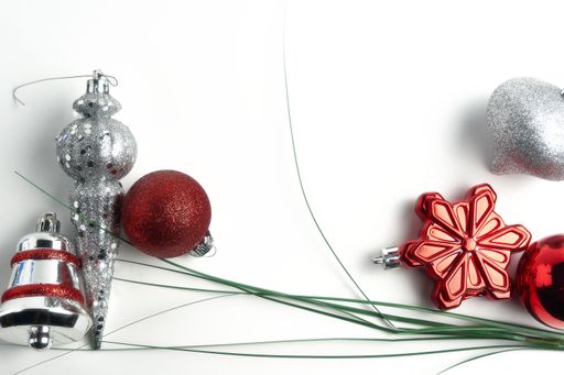 A top view of decorations for Christmas on a white surface with space for text