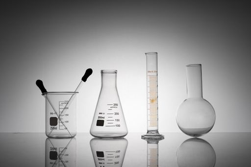 A closeup shot of laboratory flasks, beakers, and tubes