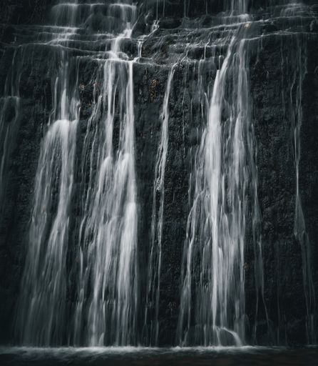 A scenic view of a waterfall cascading down the rocks