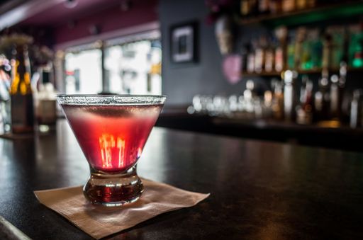 A selective focus shot of a nice alcoholic cocktail served on a bar counter
