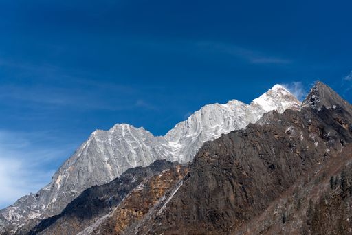 A scenic view of Mount Siguniang slopes under the clear blue sky, Qionglai Mountains in Western China