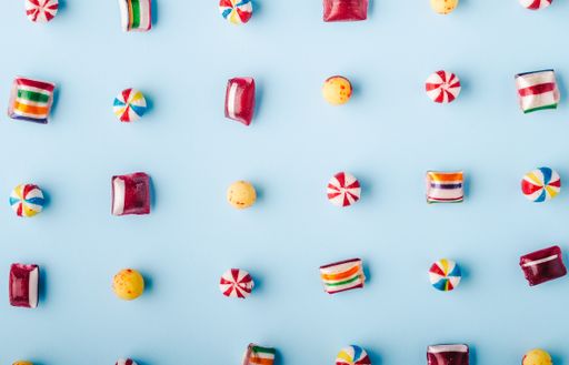A high angle shot of colorful candies on a light blue background - perfect for a cool wallpaper