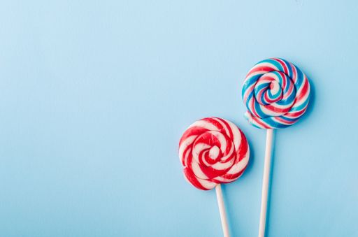 A high angle shot beautiful lollipops on a light blue background - perfect for a cool wallpaper