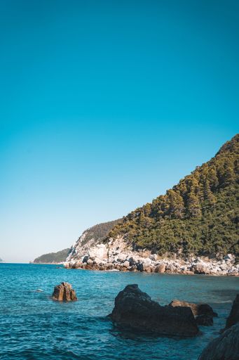 An idyllic image of a tranquil ocean with rocks in the foreground, Skopelos island, Greece