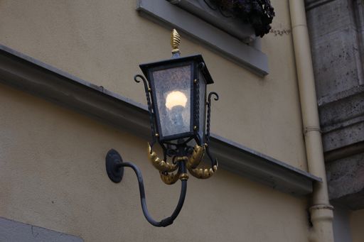 A low angle shot of an old street lamp illuminating the way for passersby