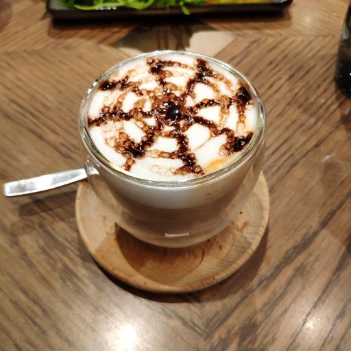A closeup shot of a cup of the latte art coffee
