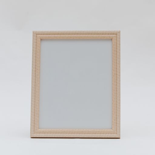 A vertical shot of a wooden photo frame on an isolated white background