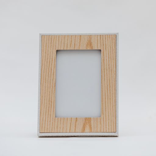 A vertical shot of a wooden photo frame on an isolated white background