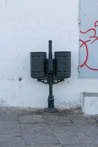 Metal dustbins on the side of the street,