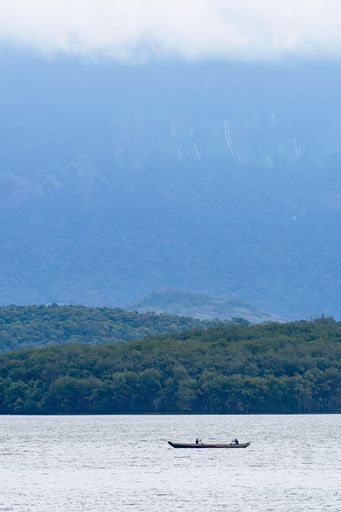 A vertical shot of a boat in the Chittar Lake at the edge of Western Ghats, Kanyakumari, India
